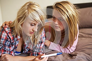 Two Teenage Girls Lying On Bed