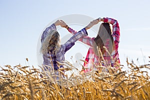 Two teenage girls making infinity sign