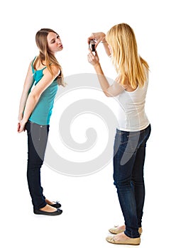 Two teenage girls photographing on camera