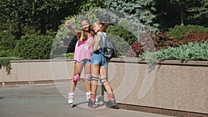 Two teenage girls on roller skates make selfie