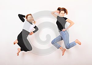 Two teenage girls smiling and jumping friends