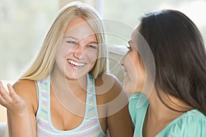 Two Teenage Girls Smiling To Each Other