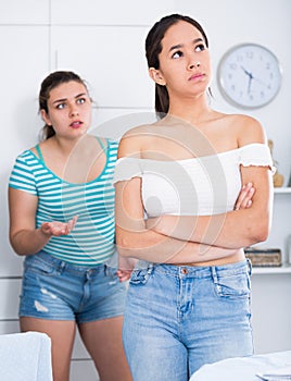 Two teenage girls squabbling at home