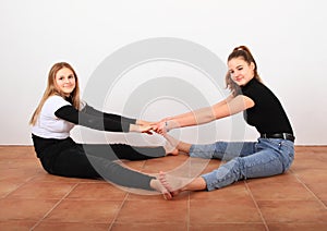 Two teenage girls stretching