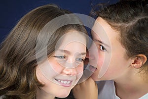 Two teenage girls telling secret