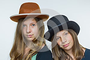 Two teenage girls wearing hats