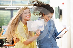 Two Teenage Pupils Celebrating Successful Exam Result