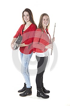 Two teenage sisters play flute and guitar in studio