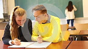 Two teenage students studying together in classroom. Education concept