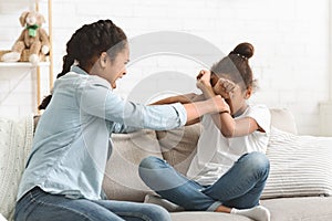 Two teenaged girls fighting at living room