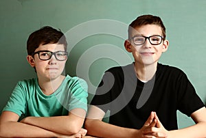 Two teenager boys in myopia glasses close up photo