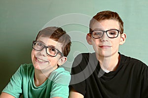 Two teenager boys in myopia short sight glasses