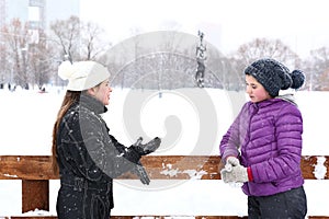 Two teenager girl on the snowy white background