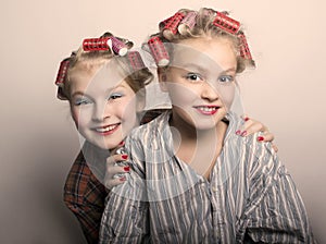 Two teenager girls playing Housewives, do yourself hairstyles and makeup having fun photo