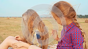 Two Teenager Girls Sitting on Haystack Closeup