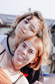 Two teenager girls together. Girl friendship. Generation Z. Red hair and curly hair