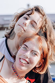 Two teenager girls together. Girl friendship. Generation Z. Red hair and curly hair