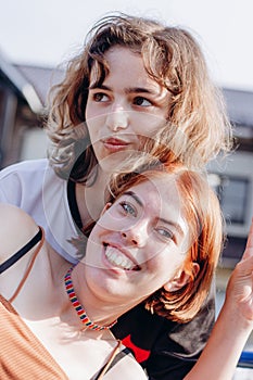 Two teenager girls together. Girl friendship. Generation Z. Red hair and curly hair