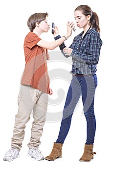 Two teenager mutually kissing their mobile phones