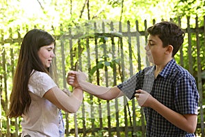 Two teenager siblings boy and girl close up photo