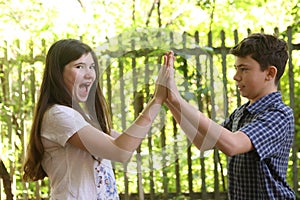 Two teenager siblings boy and girl close up photo