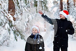 Two teenagers in Christmas hats Santa Claus having fun in the sn