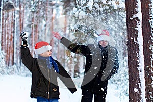 Two teenagers in Christmas hats Santa Claus having fun in the sn