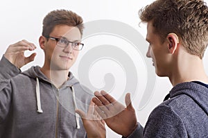 Two teenagers communicating with sign language