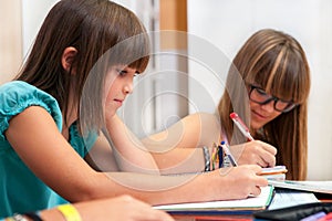 Two teenagers doing homework.