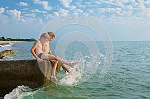 Two teenagers have fun during a vacation by the sea