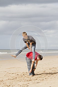 Two teenagers playing leapfrog