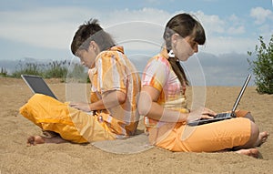 Two teens with laptops