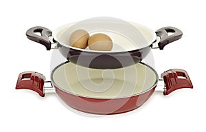 Two teflon, stainless steel pan set and eggs