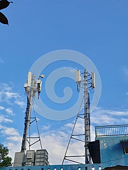 two telecommunication network towers in the blue sky which looks so beautiful and amazing