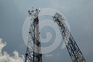 Two telecommunications towers against the sky