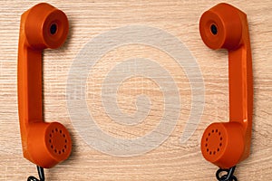 Two telephone handsets facing each other and talking