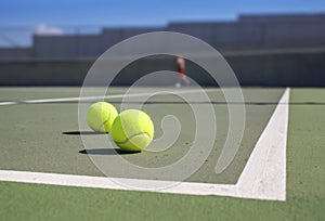 Two tennis ball near baseline