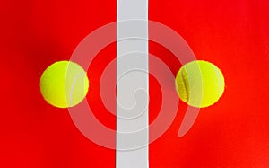 Two tennis balls divided by a field line