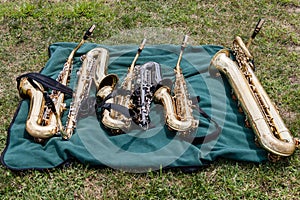 Two tenors, three altos and a bari saxophones on a blanket