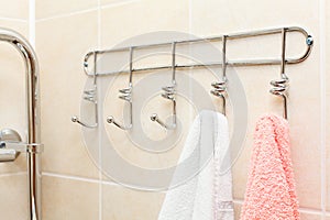 Two terry towels hanging on a hooks