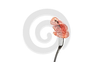 Two thin slices of cooked smoked sausage on a fork