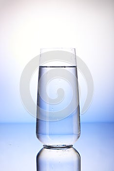 Two-thirds full drinking glass with reflection