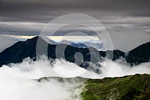 Two-thousander peaks of Carnic Alps in the clouds in Italy