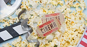 two tickets to the movies, against the background of popcorn and a film