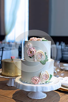 Two tier wedding cake with edible butter cream flowers.