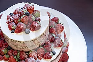 Two-tiered original cake with lots of strawberries