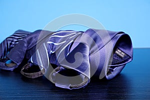 two ties laying on the floor in front of blue wall