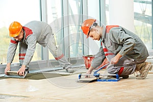 Two tilers at industrial floor tiling renovation