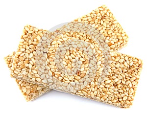 Two tiles of sesame kozinak are isolated on a white background