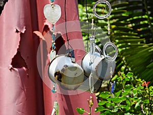 Two tin cups and a glass butterfly